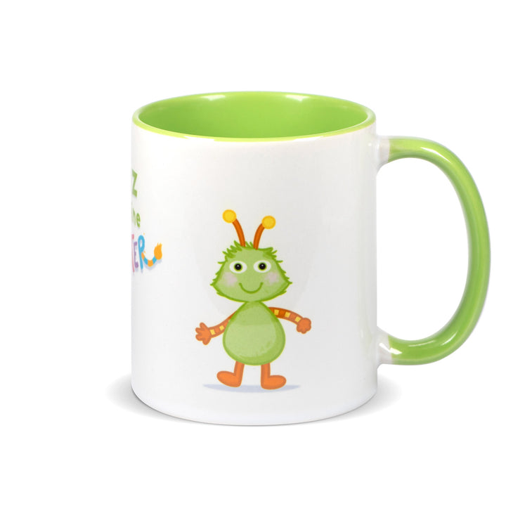 Keramiktasse mit hellgrünem Henkel und hellgrünem Innenrand, Motiv zeigt das grüne Monster „Winz“ vollständig von vorne.